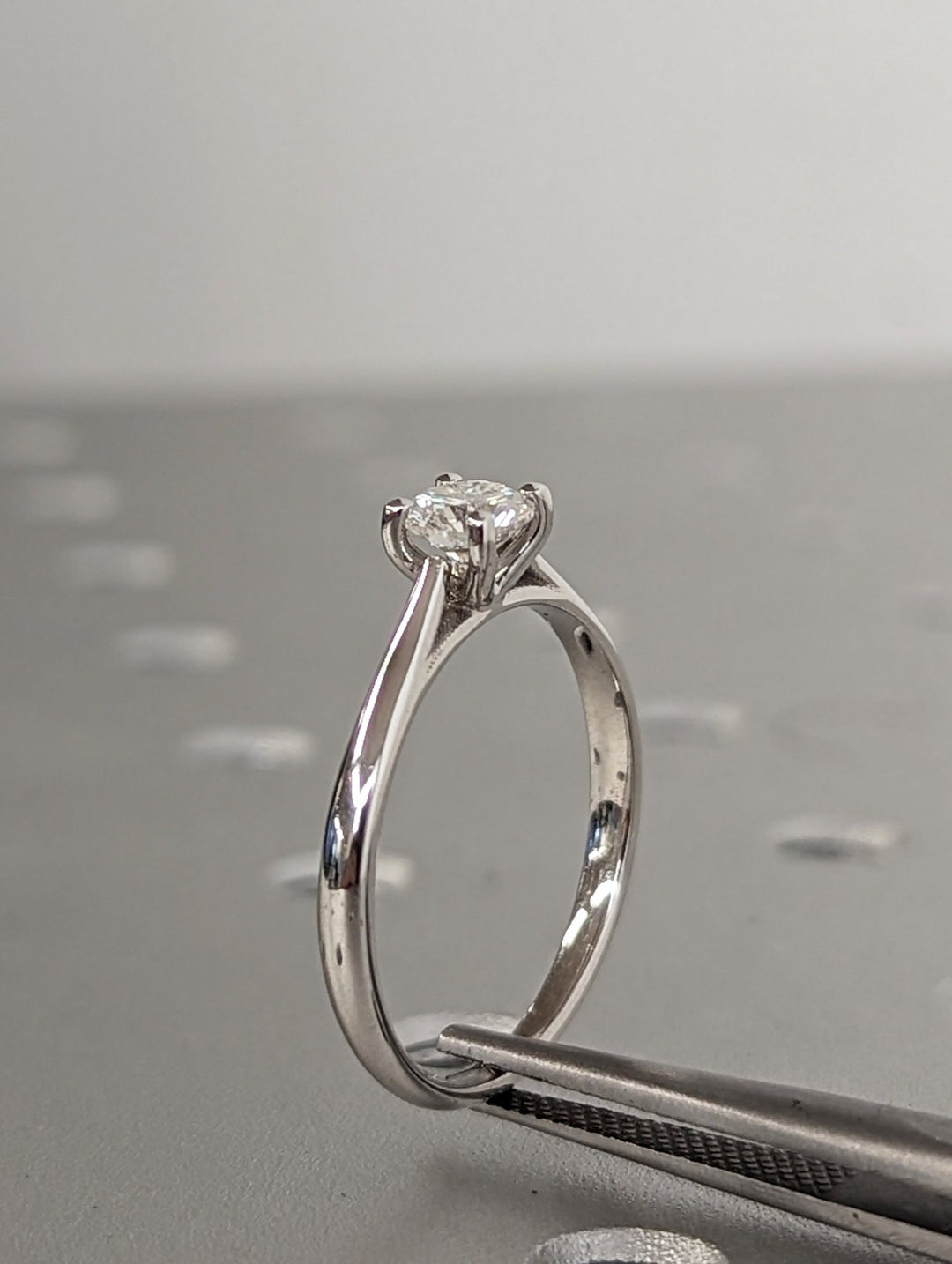 Round solitaire engagement ring viewed from the side