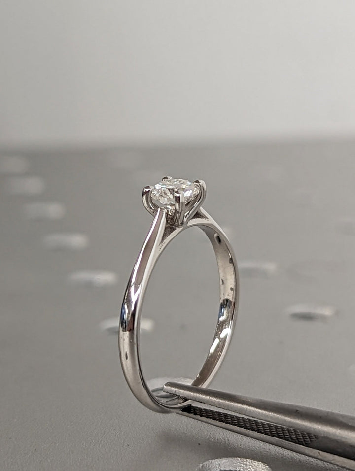Round solitaire engagement ring viewed from the side