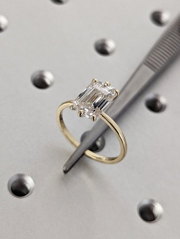 Emerald cut engagement ring side view showing band detail