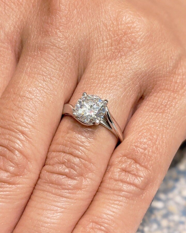 Round cut solitaire engagement ring shown in real-life wear