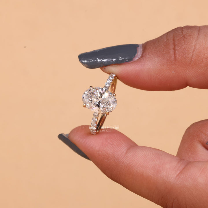 Oval hidden halo ring set with an IGI graded diamond