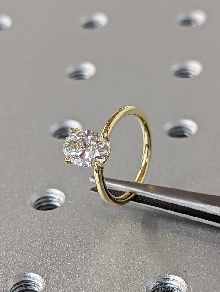 Oval solitaire diamond engagement ring available in multiple metals