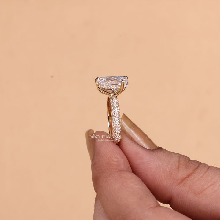 Pear pave engagement ring close-up showing F/VS1 diamond clarity