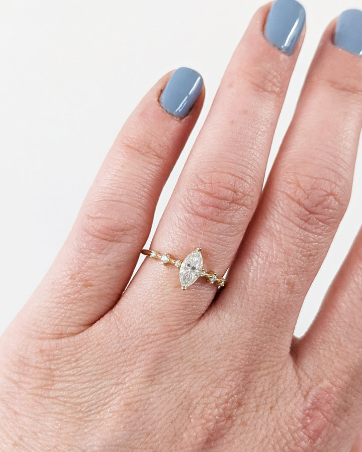 Macro shot of marquise cut diamond facets in pave ring setting