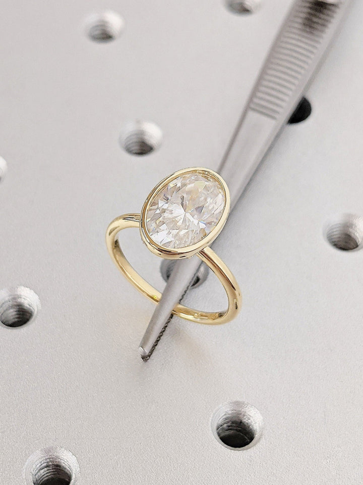 Oval bezel ring set with an IGI graded diamond