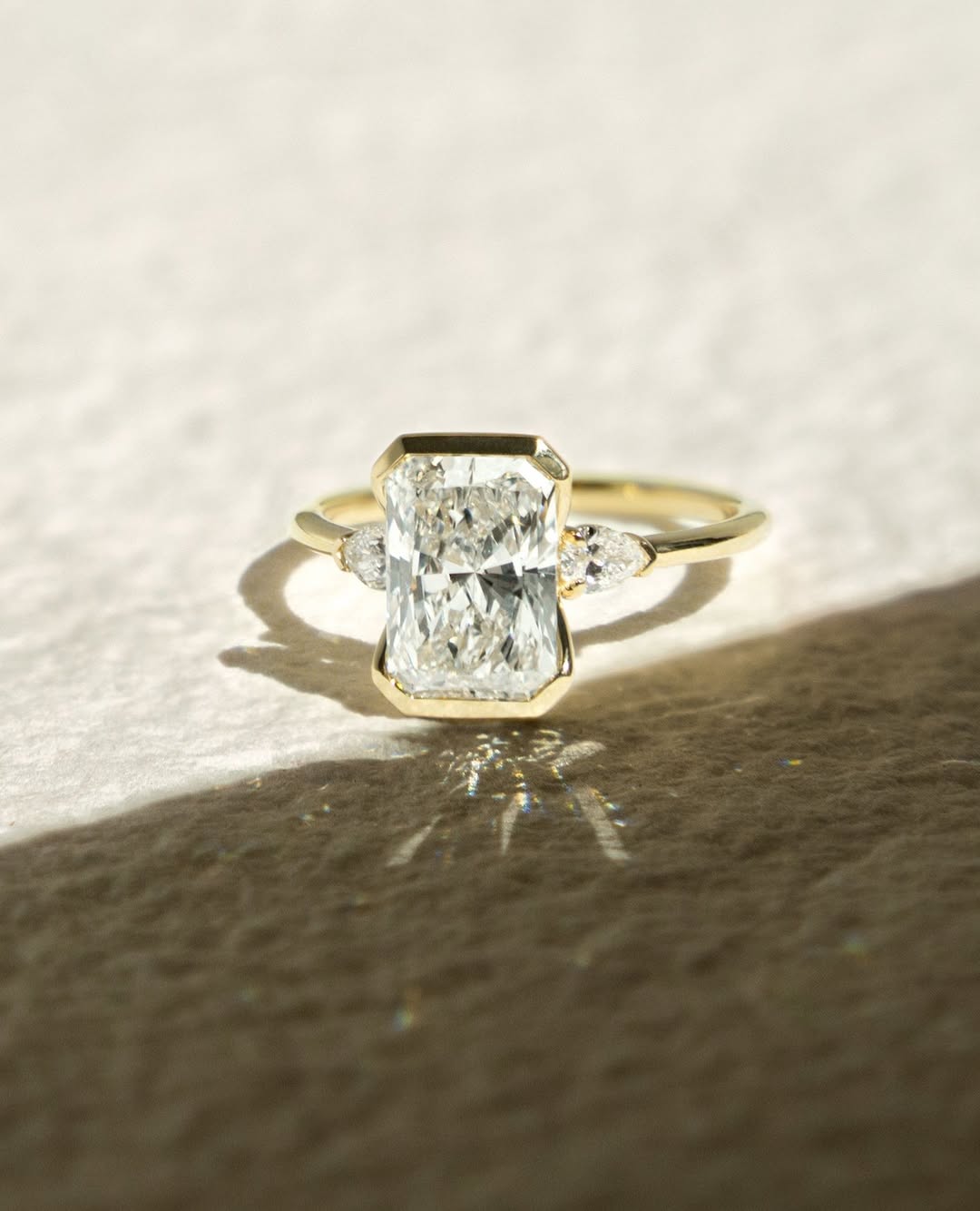 Radiant bezel engagement ring shown on hand for true-to-life sizing