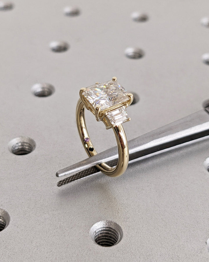 Radiant solitaire engagement ring shown on hand for true-to-life sizing