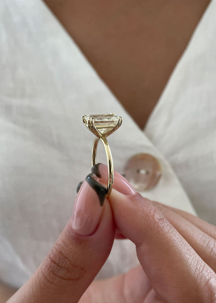 Close-up of radiant cut center diamond in solitaire engagement ring