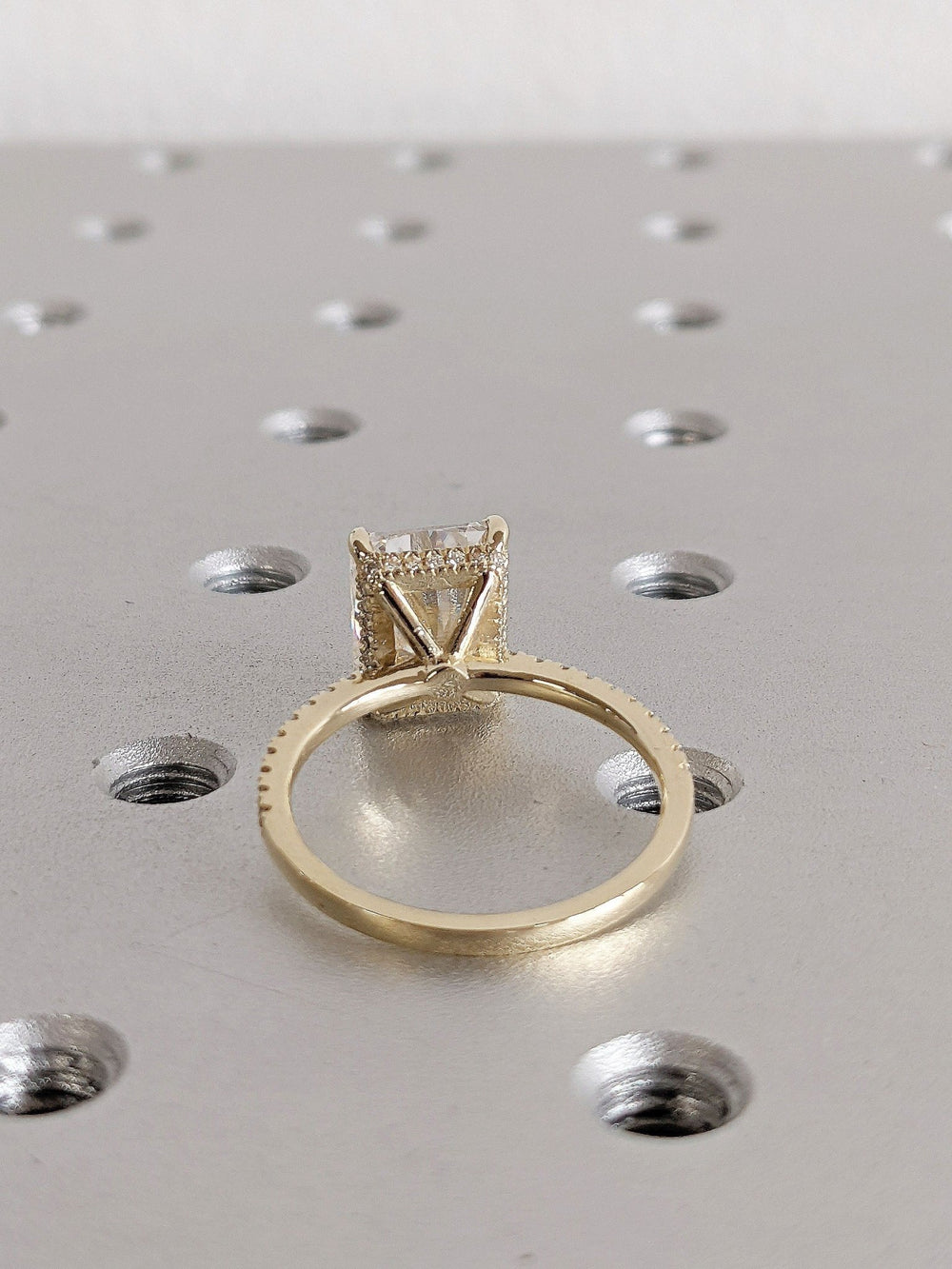 Radiant hidden halo engagement ring shown on hand for true-to-life sizing