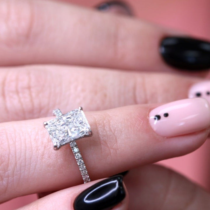 Profile view of radiant cut hidden halo engagement ring band