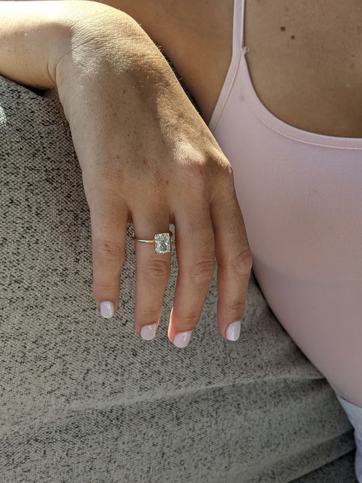 Close-up of radiant cut center diamond in solitaire engagement ring