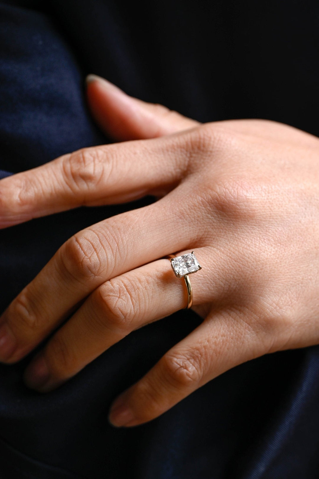 Macro shot of radiant cut diamond facets in hidden halo ring setting