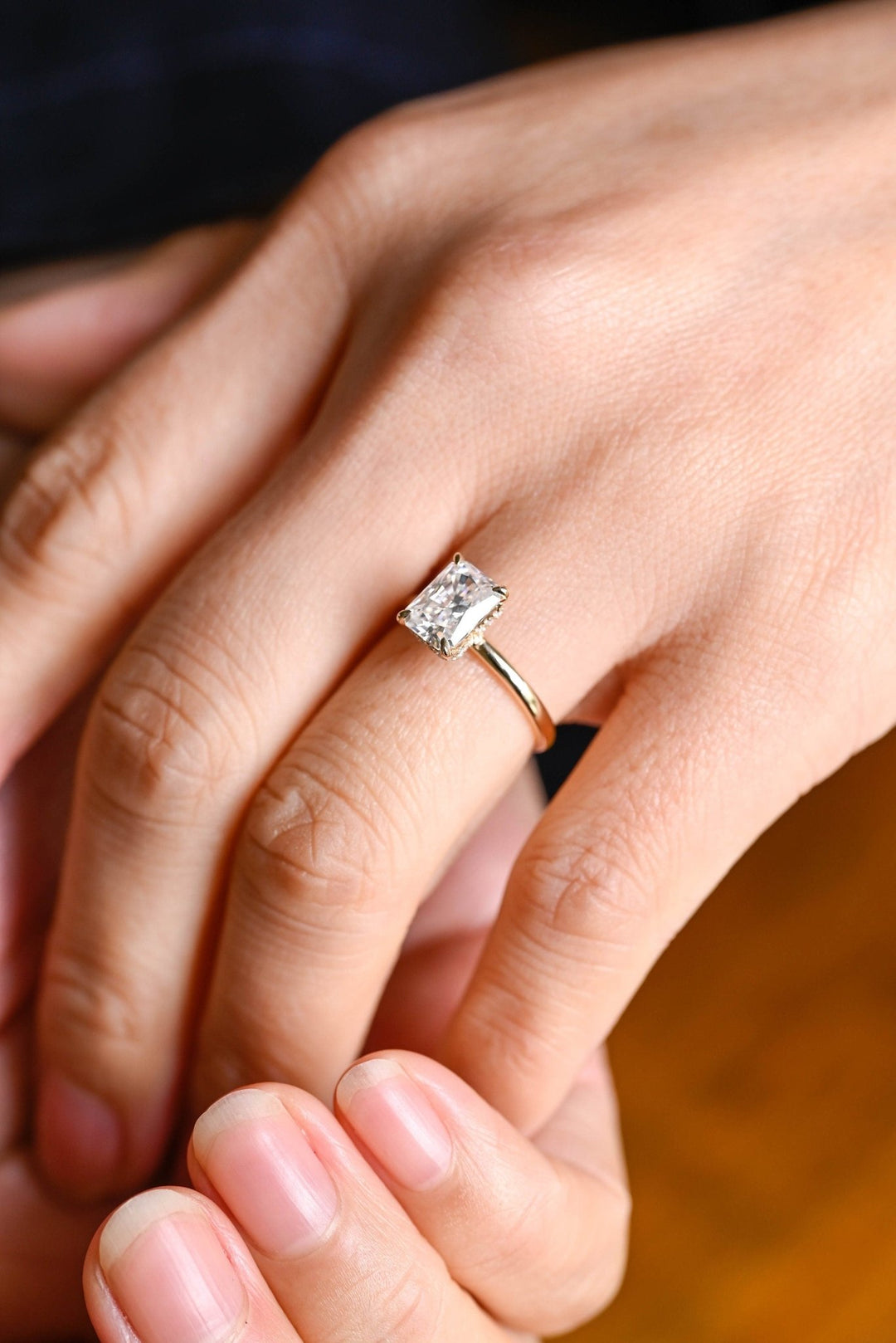 Close-up of radiant cut center diamond in hidden halo engagement ring