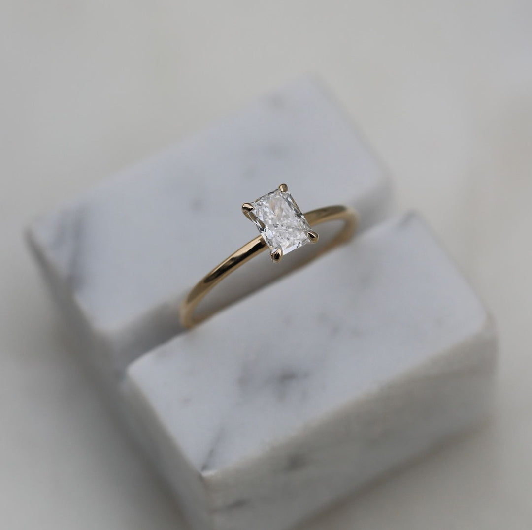 Radiant solitaire lab grown diamond ring side profile in gold setting