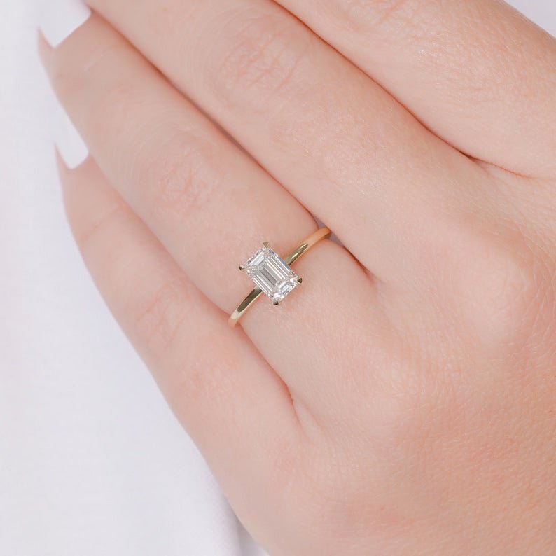 Emerald hidden halo engagement ring viewed from the side