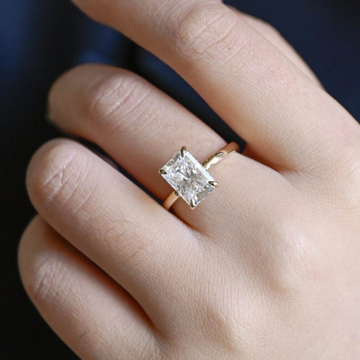 Radiant hidden halo engagement ring photographed in natural light