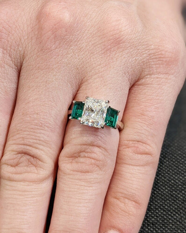 Radiant three stone diamond ring presented in signature gift packaging