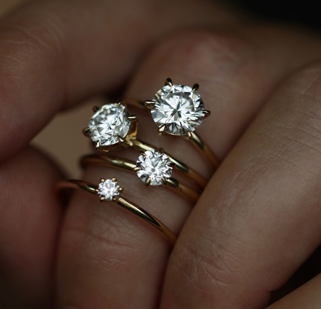Round solitaire engagement ring offered in gold and platinum