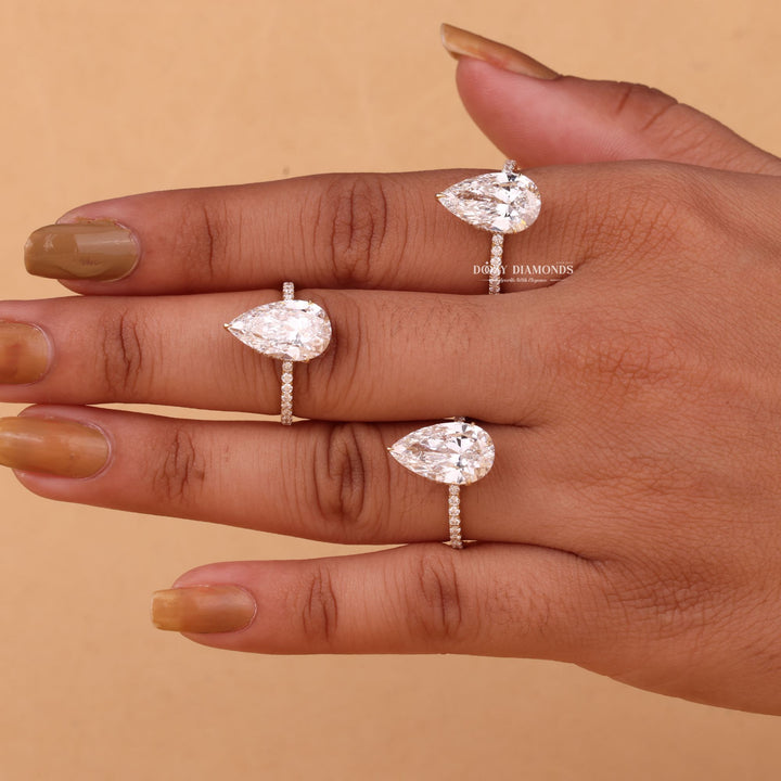 Pear hidden halo lab grown diamond ring fitted on finger