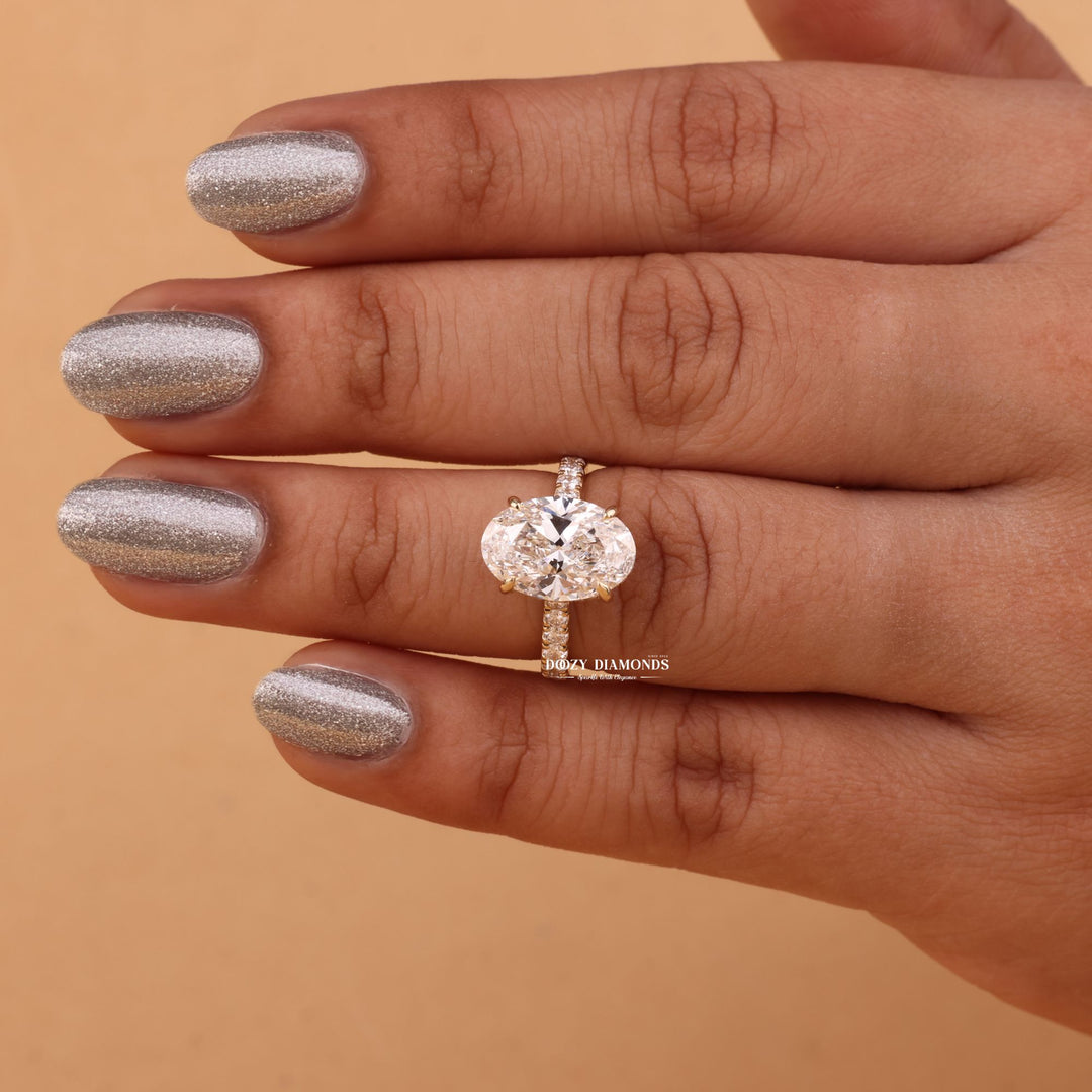 Detailed close-up of oval hidden halo diamond engagement ring