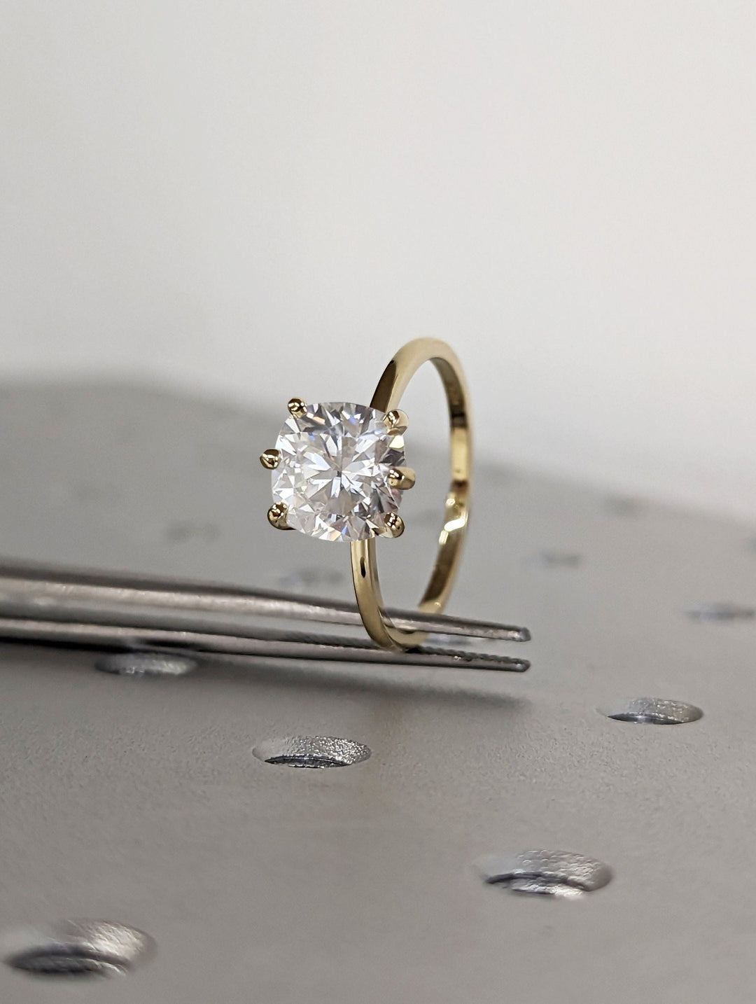 Cushion solitaire diamond engagement ring available in multiple metals
