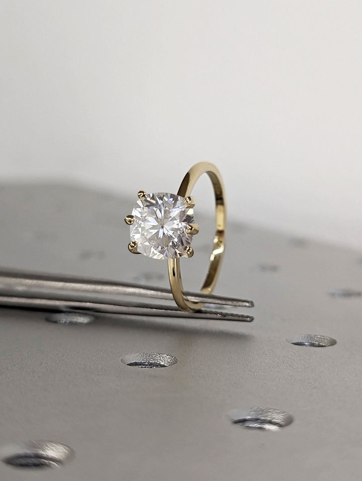 Cushion solitaire diamond engagement ring available in multiple metals