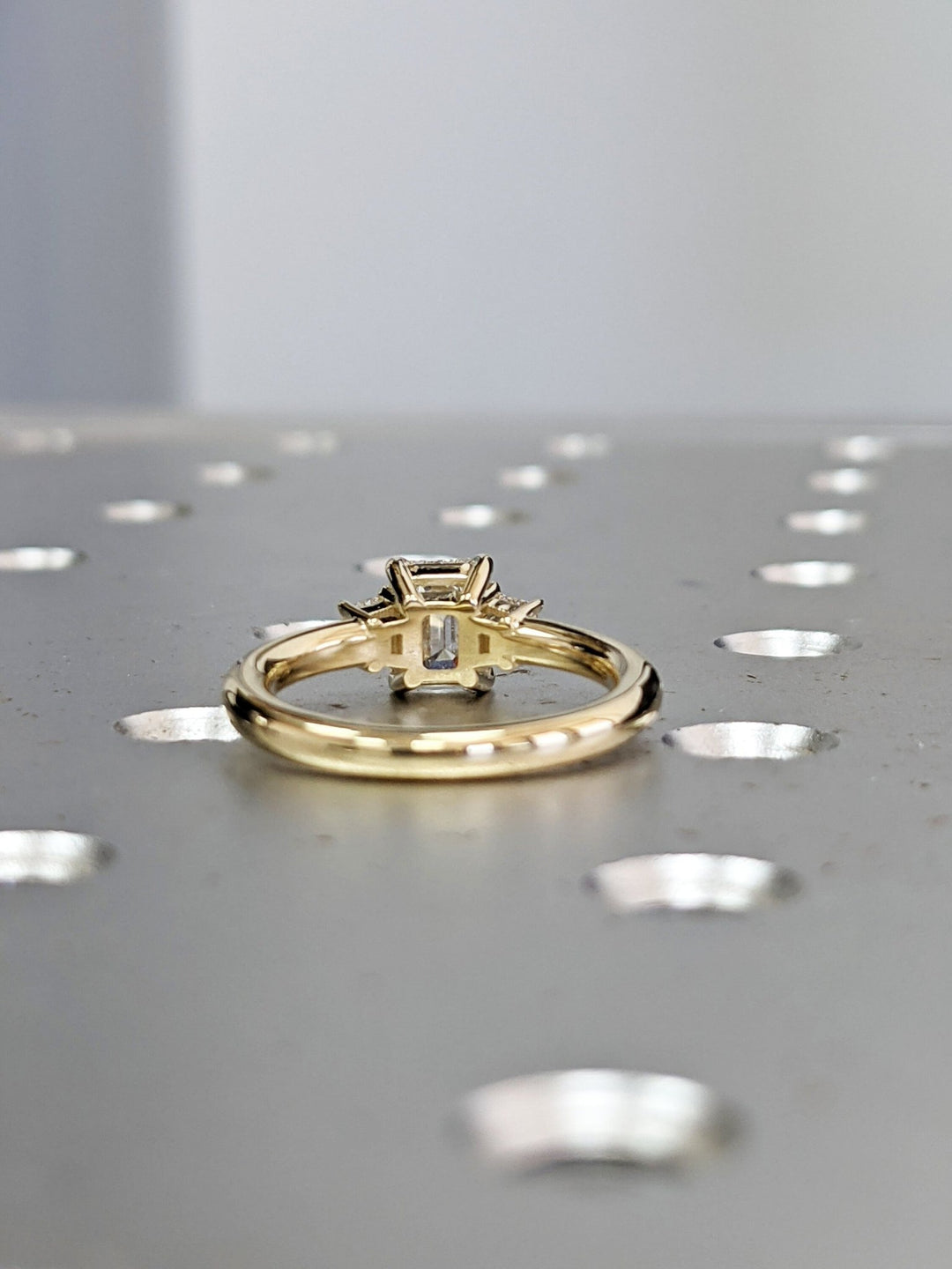 Emerald cut engagement ring side view showing band detail