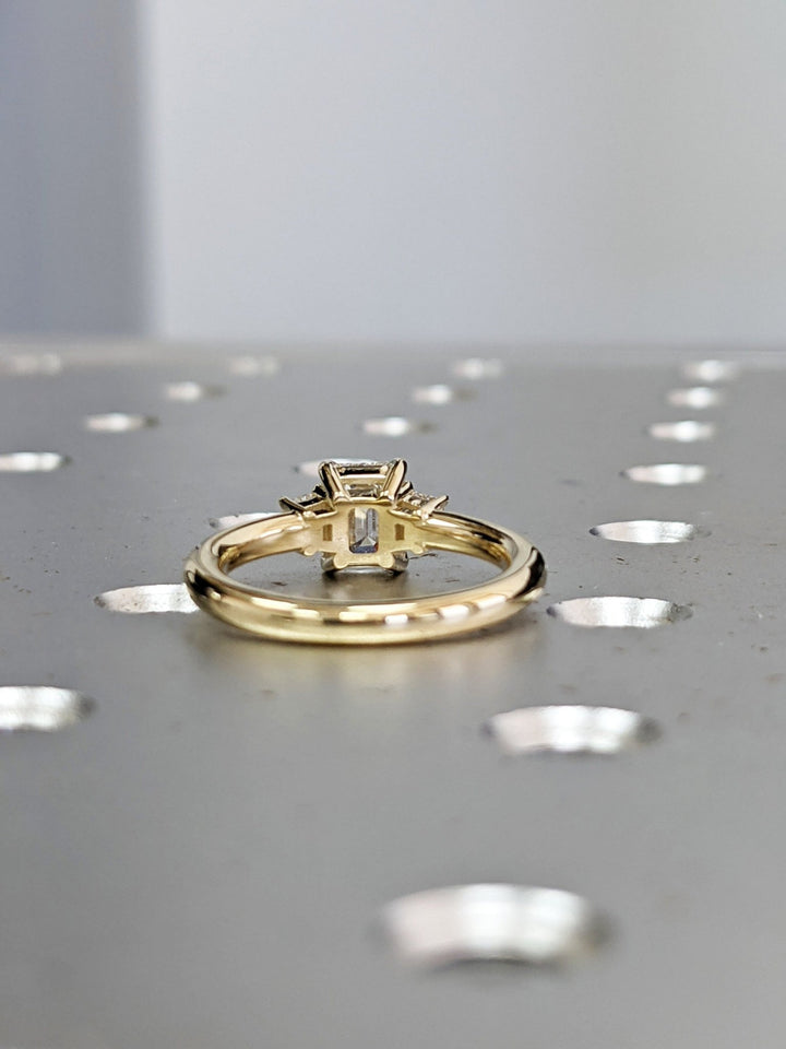 Emerald cut engagement ring side view showing band detail