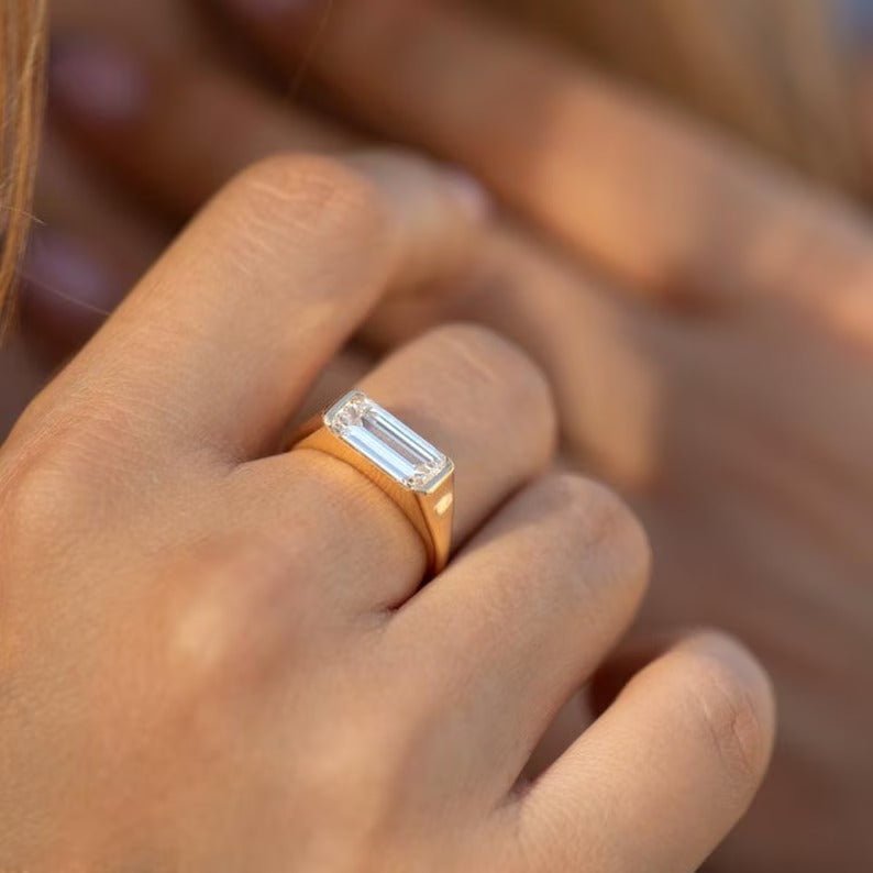 Detailed close-up of emerald east west diamond engagement ring