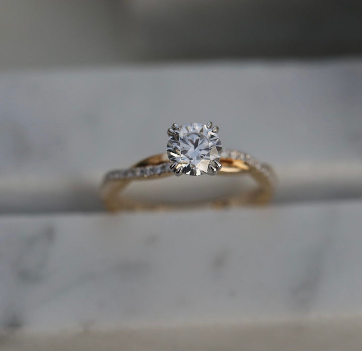 Close-up of round cut center diamond in solitaire engagement ring