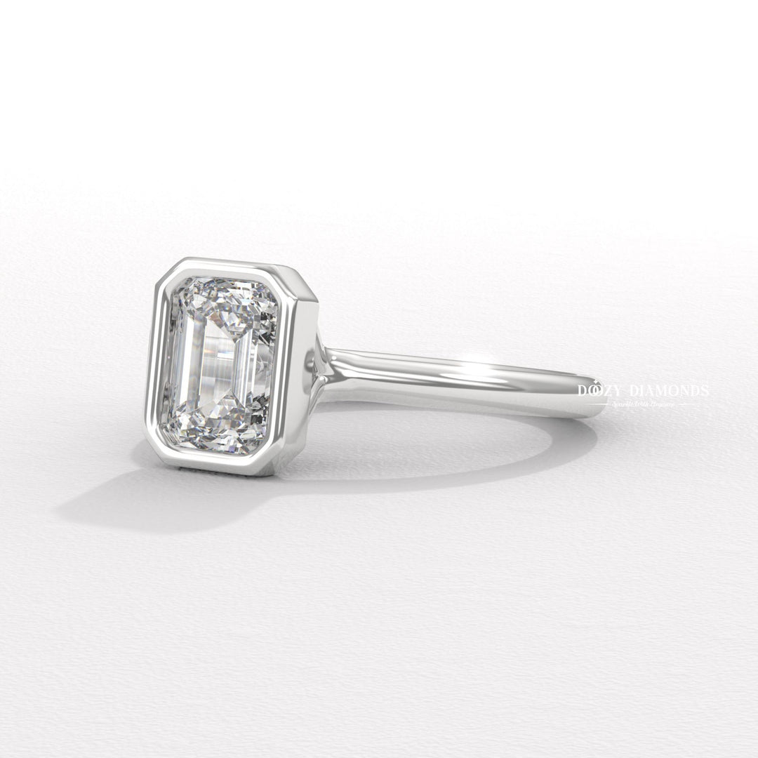 Emerald bezel engagement ring viewed from the side