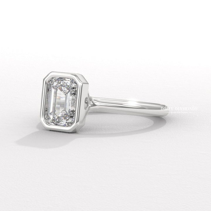 Emerald bezel engagement ring viewed from the side