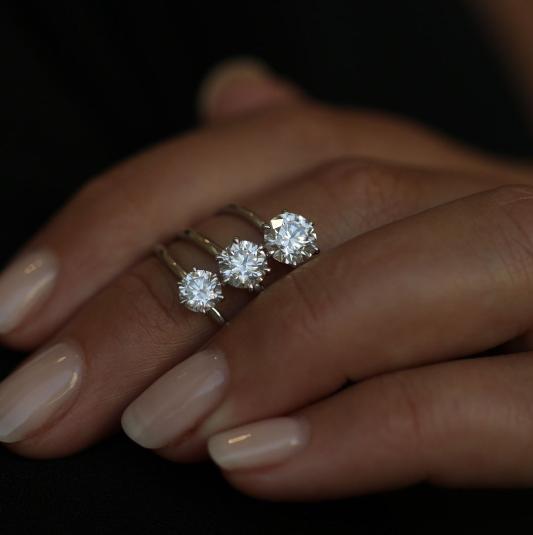 Round cut engagement ring shown with authenticity certificate