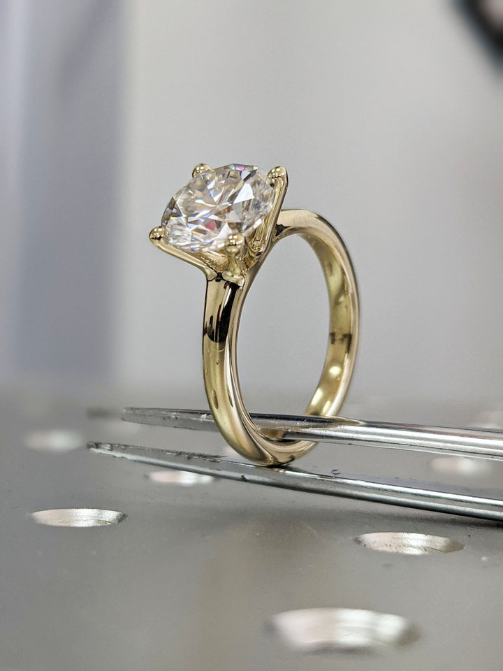 Round cut diamond ring worn on hand