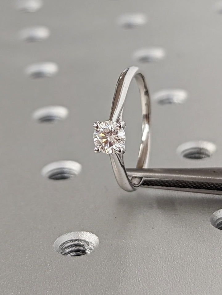Round solitaire engagement ring shown on hand for true-to-life sizing