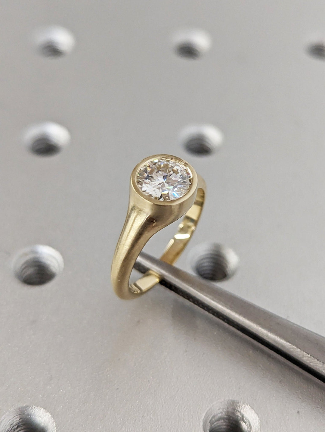 Round cut engagement ring side view showing band detail
