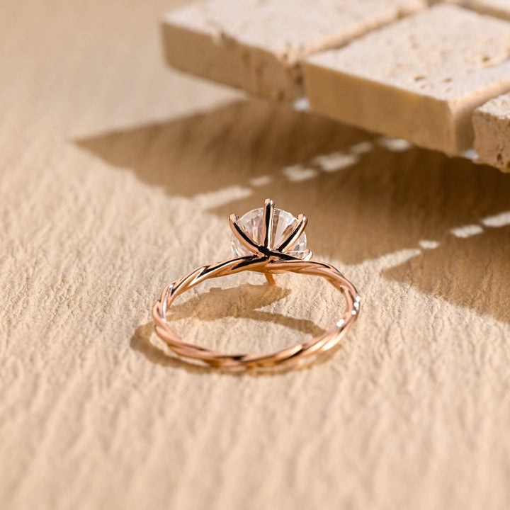 Lifestyle shot of round solitaire diamond ring on hand