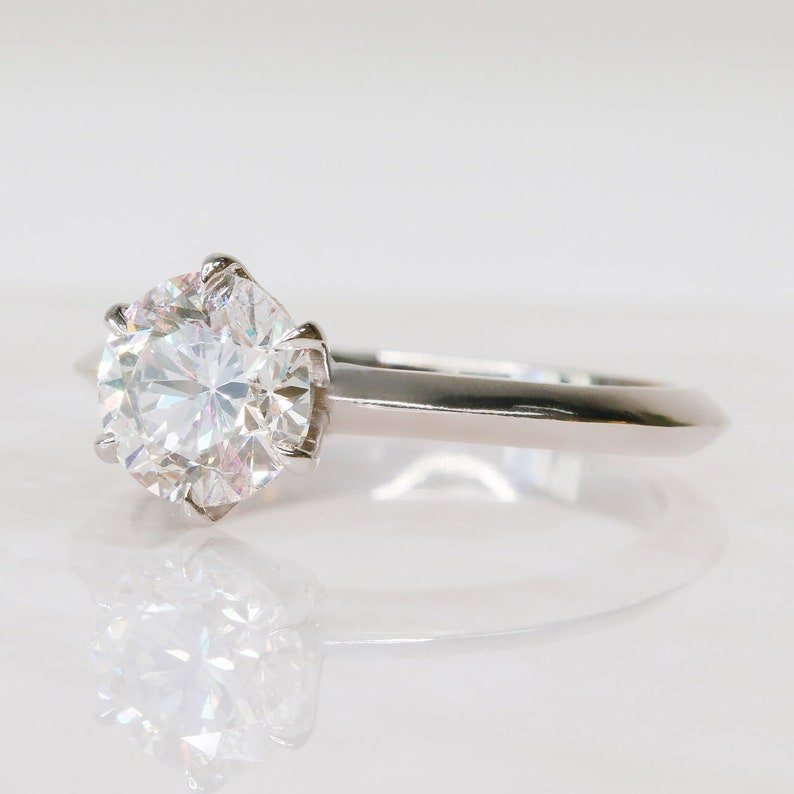 Round solitaire engagement ring photographed in natural light