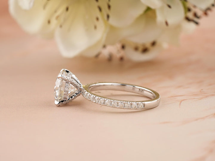 Lifestyle shot of round hidden halo diamond ring on hand