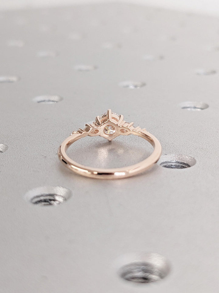 Round cluster diamond ring displayed on jewelry stand