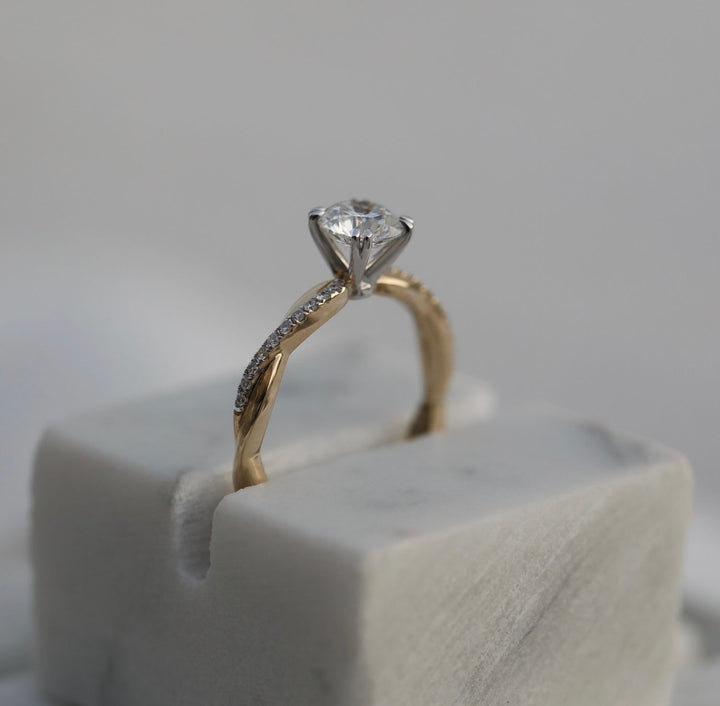 Round solitaire engagement ring close-up highlighting diamond sparkle