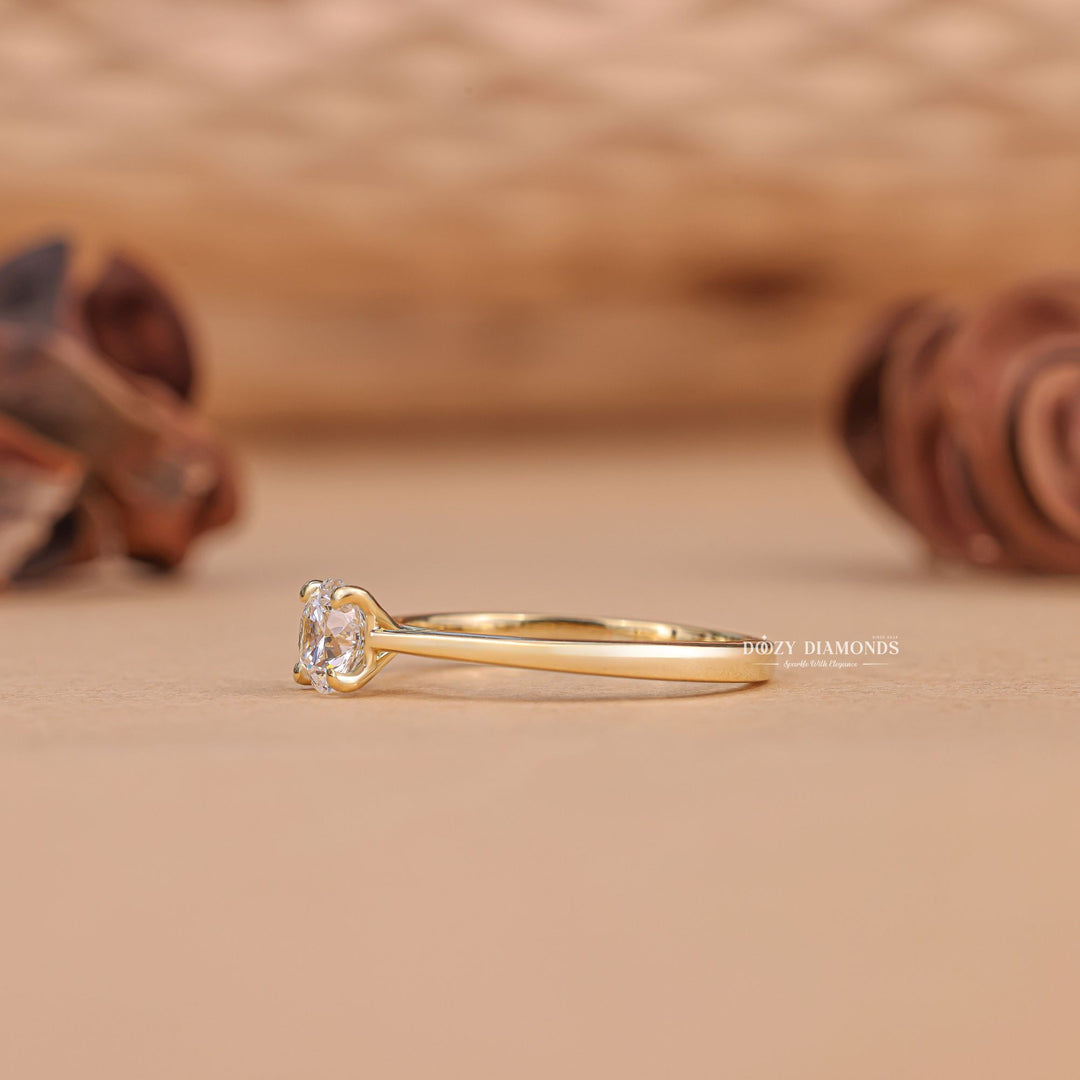 Round solitaire diamond ring displayed on jewelry stand