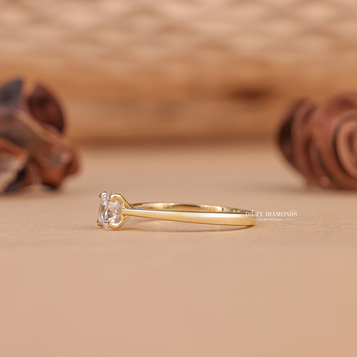 Round solitaire diamond ring displayed on jewelry stand