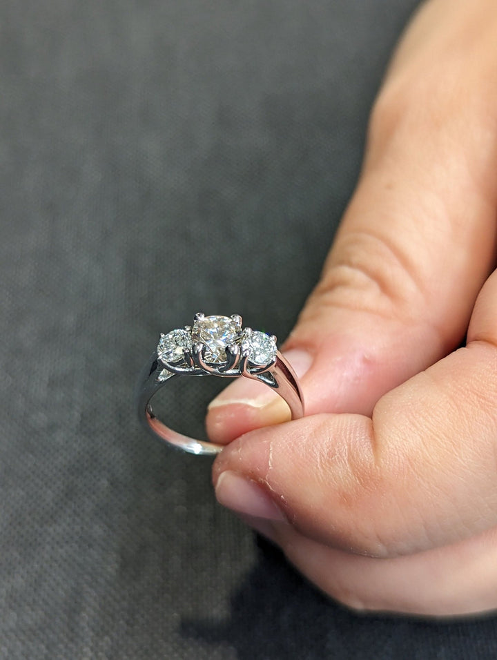 Round three stone engagement ring with IGI certificate and packaging