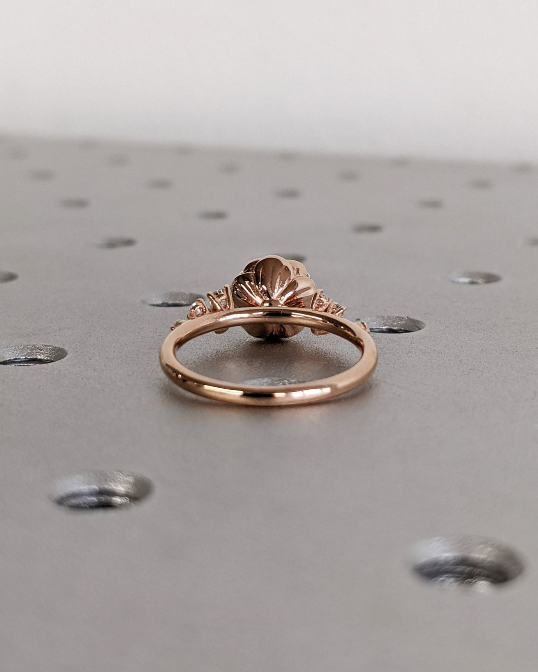 Round cluster engagement ring viewed from the side