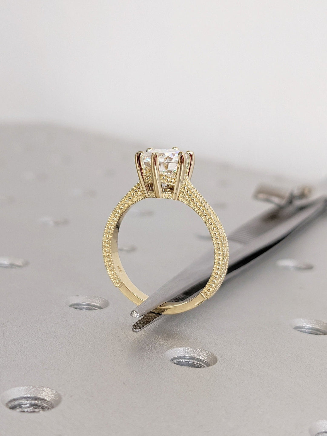 Round vintage engagement ring shown on hand for true-to-life sizing