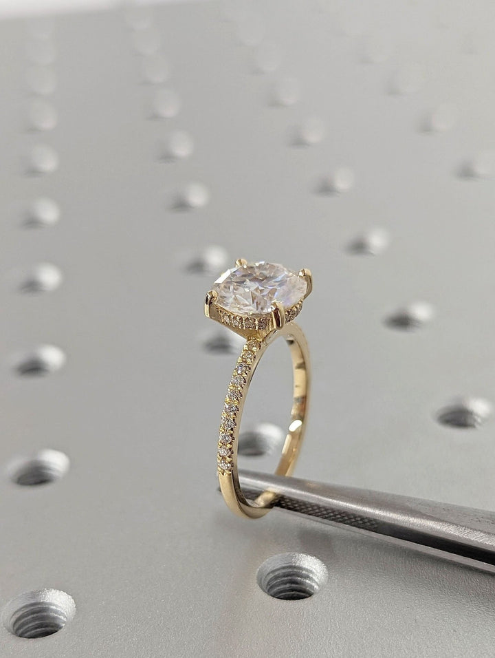 Profile view of round cut hidden halo engagement ring band