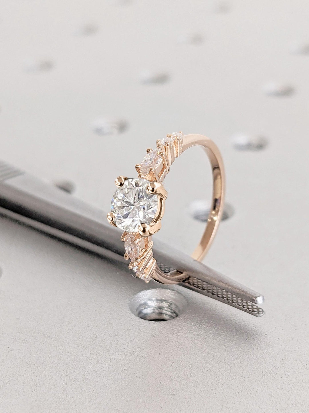 Round cluster engagement ring viewed from the side