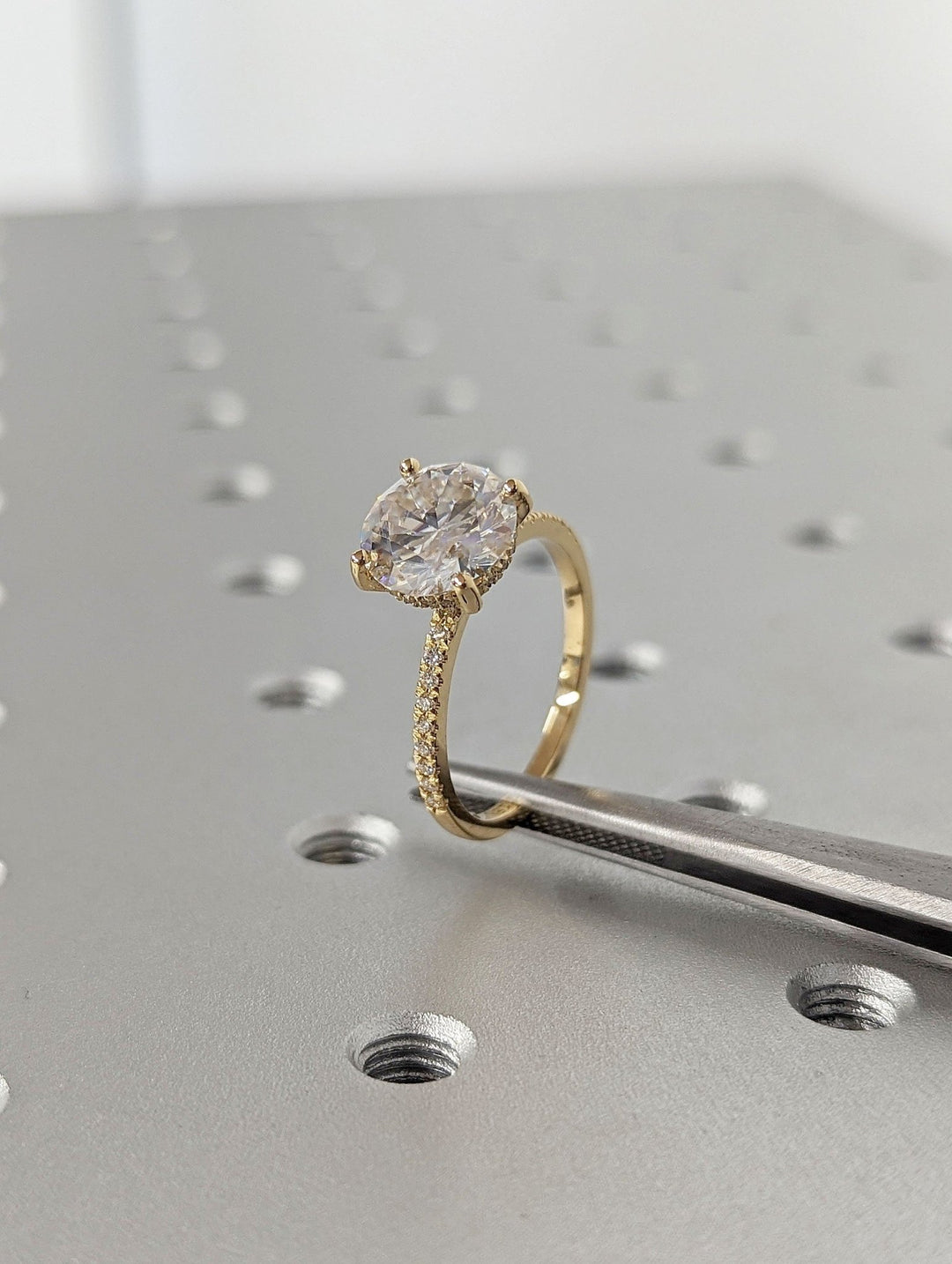 Round hidden halo engagement ring viewed from the side