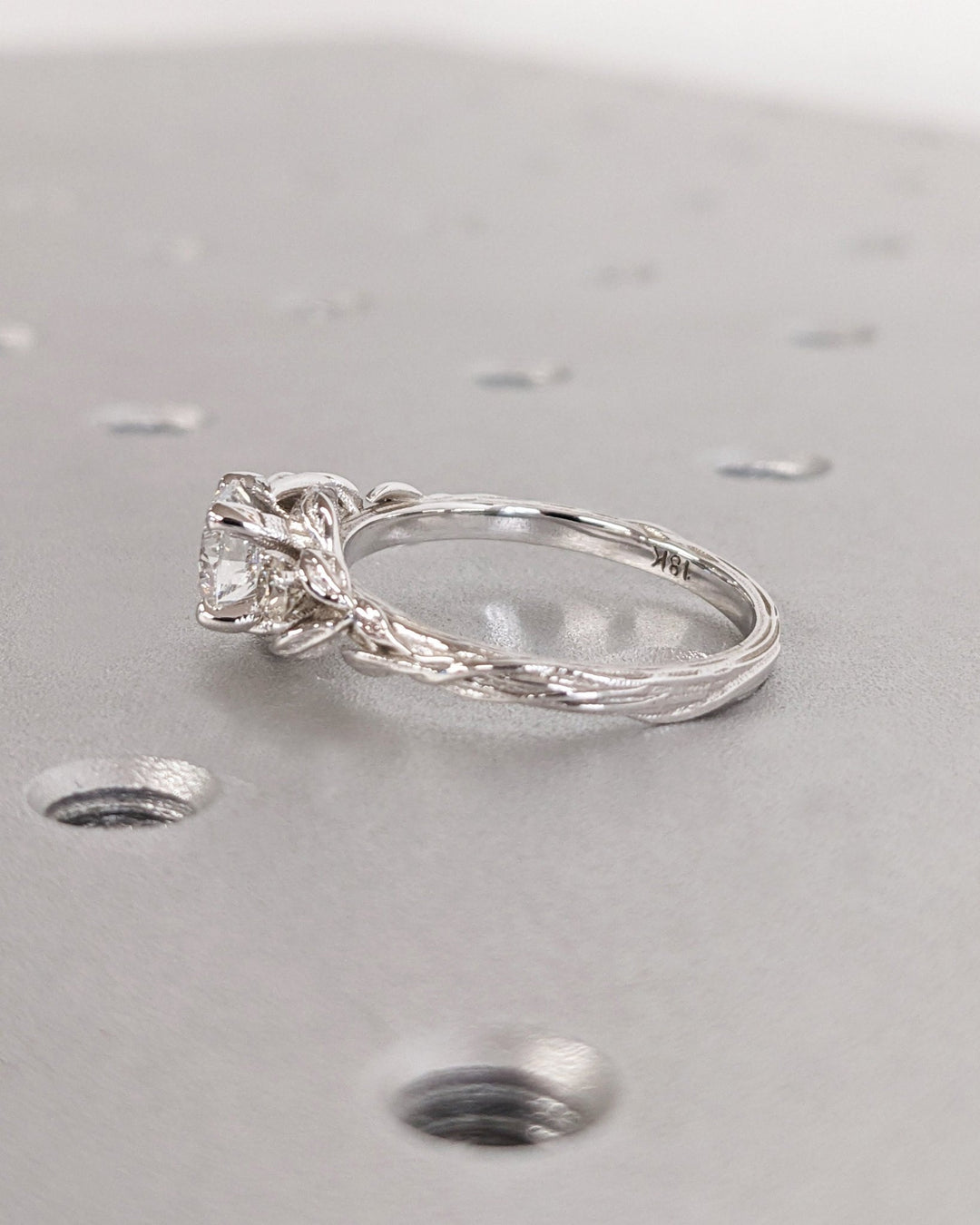 Round cut engagement ring shown with authenticity certificate